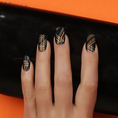 Her Royal Flyness Nail wraps, black and gold nail art, gold glitter nails holding black clutch
