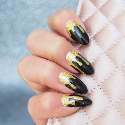 Her Royal Flyness Gold glitter drip nails holding clutch, Nail wraps black and gold